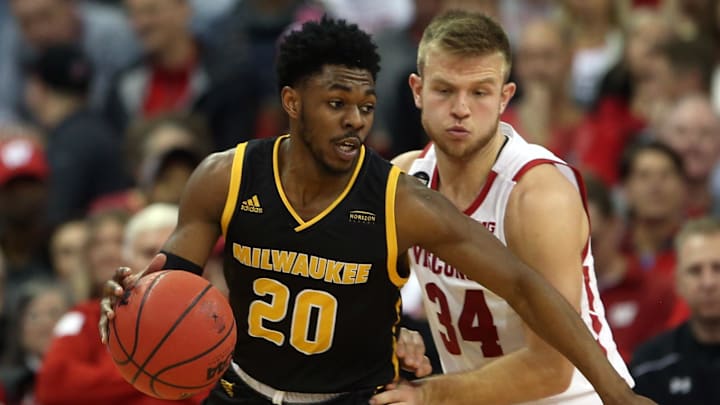 Dec 21, 2019; Madison, Wisconsin, USA; Wisconsin-Milwaukee Panthers guard Darius Roy (20) works the ball against Wisconsin Badgers guard Brad Davison (34) at the Kohl Center. 