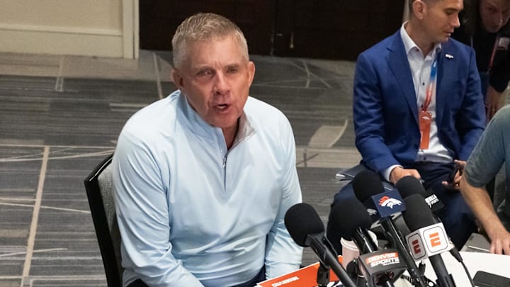 Mar 31, 2026; Phoenix, AZ, USA; Denver Broncos head coach Sean Payton (left) speaks to reporters in the media during the 2026 NFL Annual League Meeting at the Arizona Biltmore. Mandatory Credit: Mark J. Rebilas-Imagn Images