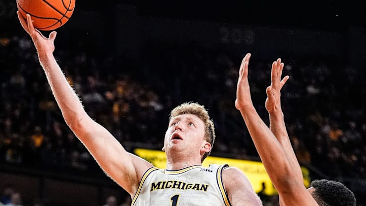 Michigan center Danny Wolf (1) makes a layup against Purdue forward Trey Kaufman-Renn (4) during the first half at Crisler Center in Ann Arbor on Tuesday, Feb. 11, 2025.