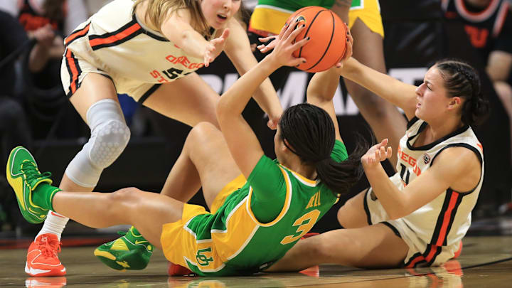 Oregon State's AJ Marotte right battles Oregon's Sofia Bell for a loose