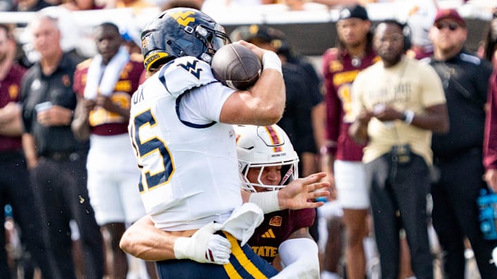Arizona State Sun Devils Keyshaun Elliott (44) tackles West Virginia Mountaineers Scotty Fox Jr. (15) during a game at Mountain America Stadium in Tempe on Nov. 15, 2025.
