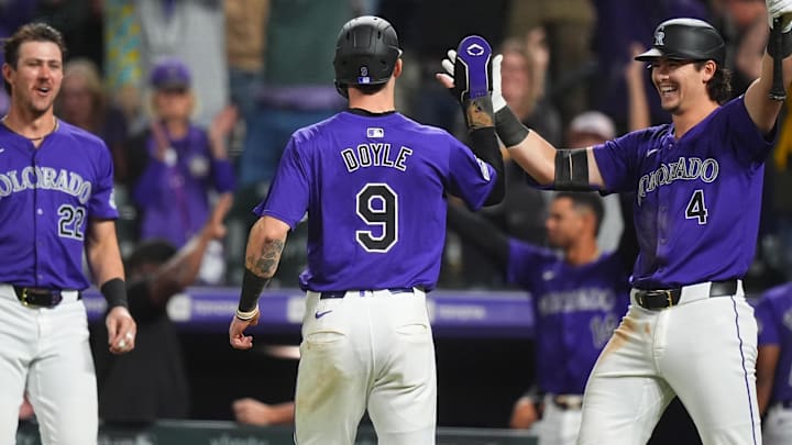 Sep 16, 2024; Denver, Colorado, USA; Colorado Rockies outfielder Brenton Doyle (9) celebrates scoring on a walk off fielding error with first base Michael Toglia (4) and outfielder Nolan Jones (22) in the ninth inning against the Arizona Diamondbacks at Coors Field. Mandatory Credit: Ron Chenoy-Imagn Images