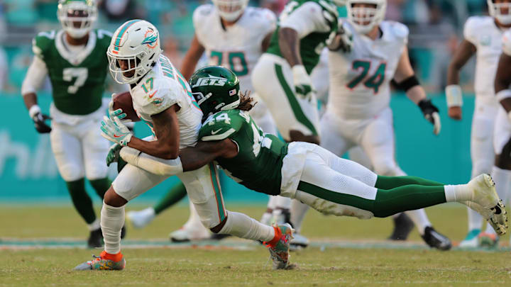 Miami Dolphins wide receiver Jaylen Waddle (17) runs with the football past New York Jets linebacker Jamien Sherwood (44) during the fourth quarter at Hard Rock Stadium in December 2024.