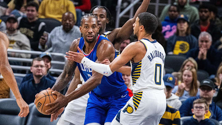 Dec 18, 2023; Indianapolis, Indiana, USA: LA Clippers forward Kawhi Leonard (2) looks to pass the ball while Indiana Pacers guard Tyrese Haliburton (0) defends in the second half at Gainbridge Fieldhouse. Mandatory Credit: Trevor Ruszkowski-Imagn Images