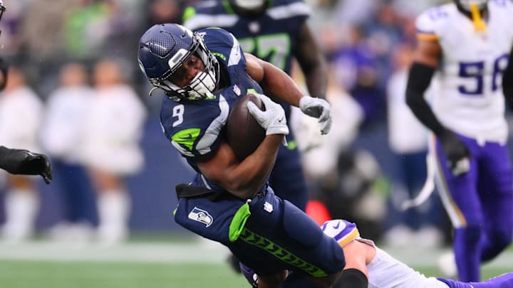 Dec 22, 2024; Seattle, Washington, USA; Seattle Seahawks running back Kenneth Walker III (9) stretches for extra yards during a run play against the Minnesota Vikings in the second half at Lumen Field. Mandatory Credit: Steven Bisig-Imagn Images