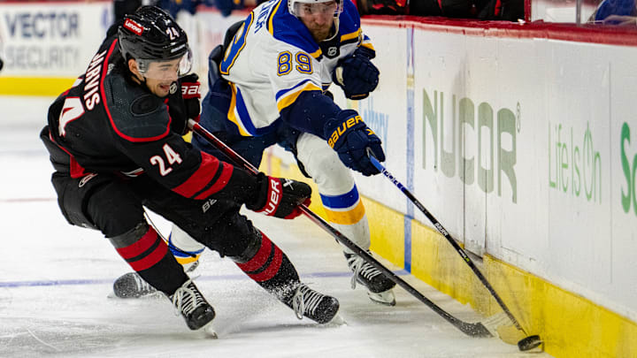 Seth Jarvis battles for the puck