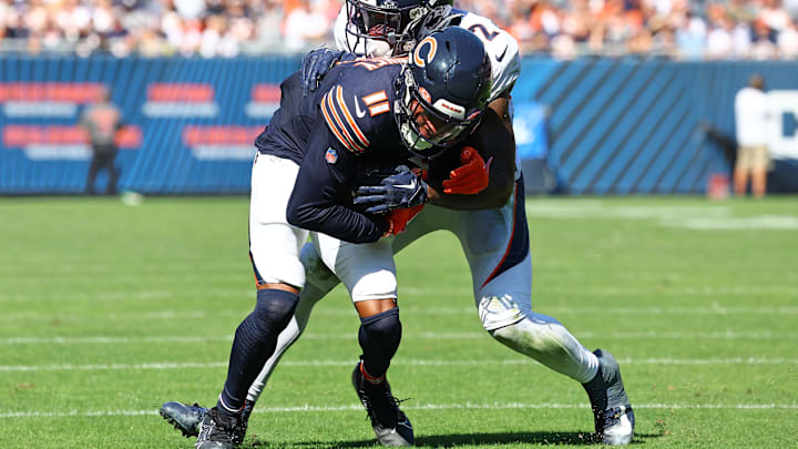 Oct 1, 2023; Chicago, Illinois, USA; Chicago Bears wide receiver Darnell Mooney (11) runs the ball after a catch against Denver Broncos safety Delarrin Turner-Yell (32) during the second half at Soldier Field. Mandatory Credit: Mike Dinovo-Imagn Images