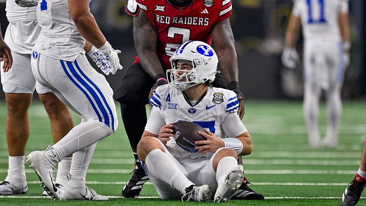 Dec 6, 2025; Arlington, TX, USA; Texas Tech Red Raiders defensive lineman Lee Hunter (2) helps up BYU Cougars quarterback Bear Bachmeier (47) during the game between the Red Raiders and the Cougars at AT&T Stadium. Mandatory Credit: Jerome Miron-Imagn Images Dec 6, 2025; Arlington, TX, USA; Texas Tech Red Raiders defensive lineman Lee Hunter (2) helps up BYU Cougars quarterback Bear Bachmeier (47) during the game between the Red Raiders and the Cougars at AT&T Stadium. Mandatory Credit: Jerome Miron-Imagn Images