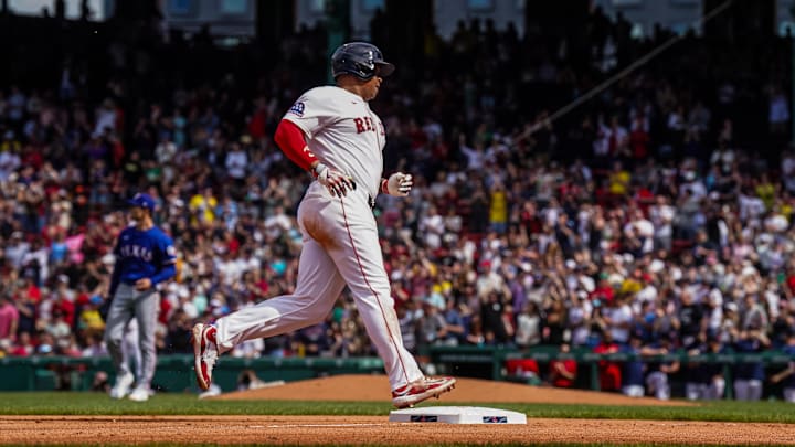 May 8, 2025; Boston, Massachusetts, USA; Boston Red Sox designated hitter Rafael Devers (11) hits a home run against the Texas Rangers in the seventh inning at Fenway Park. Mandatory Credit: David Butler II-Imagn Images