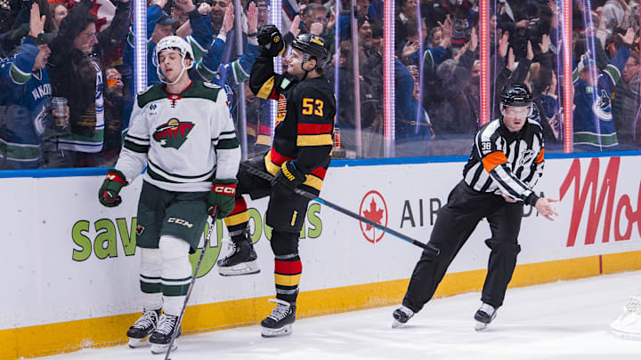 Mar 7, 2025; Vancouver, British Columbia, CAN; Minnesota Wild defenseman Brock Faber (7) reacts as Vancouver Canucks forward Teddy Blueger (53) celebrates his goal in the third period at Rogers Arena. Mandatory Credit: Bob Frid-Imagn Images