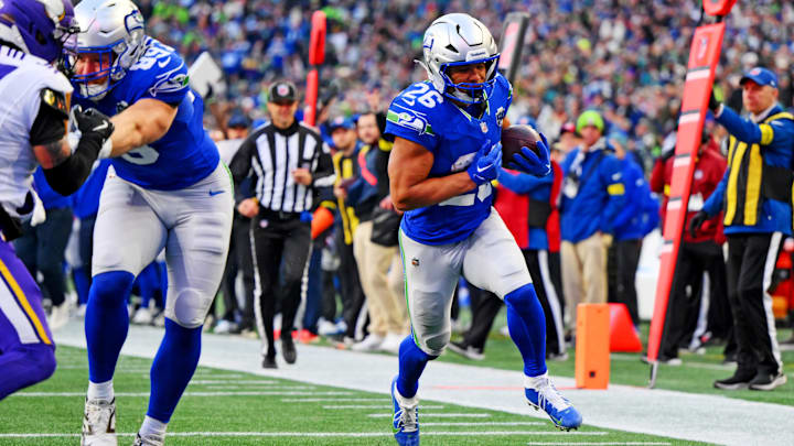 Nov 30, 2025; Seattle, Washington, USA; Seattle Seahawks running back Zach Charbonnet (26) scores a touchdown during the second half against the Minnesota Vikings at Lumen Field. Mandatory Credit: Steven Bisig-Imagn Images