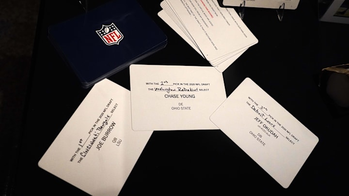 Apr 28, 2021; Canton, Ohio, USA; The draft cards of the top three picks in the 2020 NFL Draft of the top three picks, Joe Burrow (Cincinnati Bengals), Chase Young (Washington Redskins) and Jeff Okudah (Detroit Lions) on display at the Pro Football Hall of Fame.  