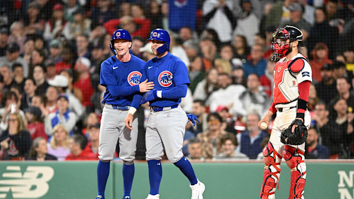 Apr 28, 2024; Boston, Massachusetts, USA; Chicago Cubs center fielder Pete Crow-Armstrong (52) and second baseman Nico Hoerner (2) react after scoring on a three-run home run hit by right fielder Mike Tauchman (not seen)  during the eighth inning of a game against the Boston Red Sox at Fenway Park. Mandatory Credit: Brian Fluharty-Imagn Images
