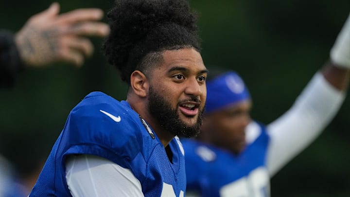 Indianapolis Colts defensive end JT Tuimoloau (91) sings while warming-up Thursday, July 31, 2025, during Colts Training Camp at Grand Park in Westfield. Indianapolis Colts defensive end JT Tuimoloau (91) sings while warming-up Thursday, July 31, 2025, during Colts Training Camp at Grand Park in Westfield.
