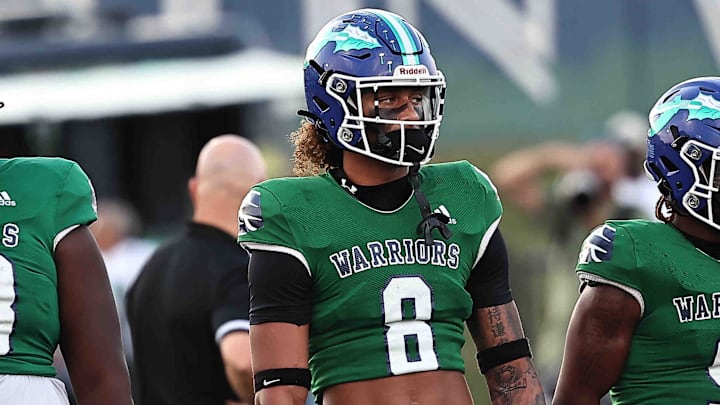 Winton Woods' Justin Hill (8) out for the coin toss before their football game against Kings Friday, Aug. 30,2024.