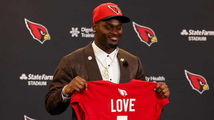Apr 24, 2026; Phoenix, AZ, USA; Arizona Cardinals first-round draft pick Jeremiyah Love poses with his jersey during a press conference at Dignity Health Arizona Cardinals Training Center. Mandatory Credit: Anna Carrington-Imagn Images