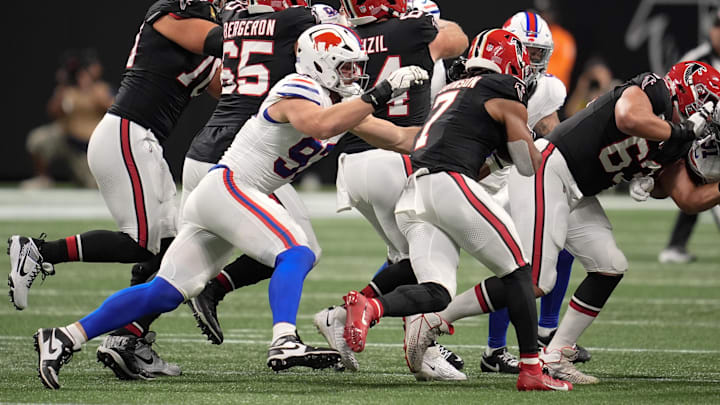 Oct 13, 2025; Atlanta, Georgia, USA; Buffalo Bills defensive end Joey Bosa (97) attempts to tackle Atlanta Falcons running back Bijan Robinson (7).