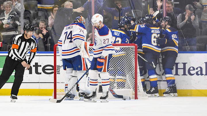 St. Louis Blues center Jordan Kyrou (25) celebrates with teammates after scoring against Edmonton Oilers goaltender Stuart Skinner (74)