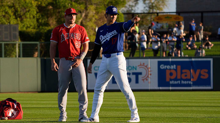 Mar 5, 2024; Phoenix, Arizona, USA; Los Angeles Dodgers two-way player Shohei Ohtani (17) and Los Angeles Angels outfielder Mike Trout (27) chat in the outfield before the start of a spring training game at Camelback Ranch-Glendale. Mandatory Credit: Allan Henry-Imagn Images Mar 5, 2024; Phoenix, Arizona, USA; Los Angeles Dodgers two-way player Shohei Ohtani (17) and Los Angeles Angels outfielder Mike Trout (27) chat in the outfield before the start of a spring training game at Camelback Ranch-Glendale. Mandatory Credit: Allan Henry-Imagn Images