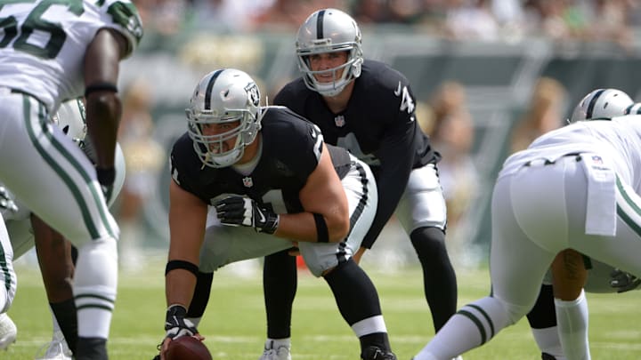 Sep 7, 2014; East Rutherford, NJ, USA; Oakland Raiders quarterback Derek Carr (4) takes the snap from center Stefen Wisniewski (61) during the game against the New York Jets at MetLife Stadium. Mandatory Credit: Kirby Lee-Imagn Images