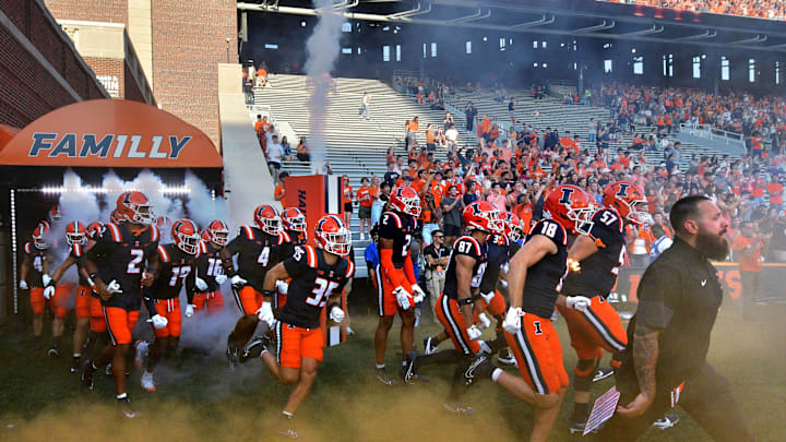 Aug 29, 2025; Champaign, Illinois, USA;  The Illinois Fighting Illini run onto the field before an NCAA game with the Western Illinois Leathernecks during at Memorial Stadium. Mandatory Credit: Ron Johnson-Imagn Images