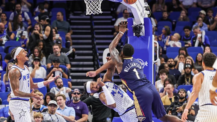 Oct 16, 2025; Orlando, Florida, USA; Orlando Magic center/forward Wendell Carter Jr. (34) is fouled by New Orleans Pelicans forward Zion Williamson (1) during the first quarter at Kia Center. Mandatory Credit: Mike Watters-Imagn Images