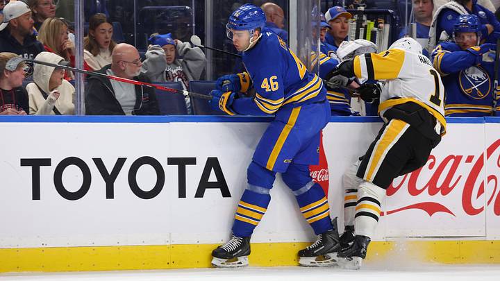 Buffalo Sabres defenseman Louis Crevier delivers a hit during a preseason game against the Pittsburgh Penguins