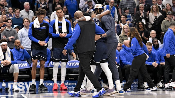 Mar 3, 2025; Dallas, Texas, USA; Dallas Mavericks guard Kyrie Irving (11) is helped off the court by forward Anthony Davis (3) during the second quarter against the Sacramento Kings at the American Airlines Center. Mandatory Credit: Jerome Miron-Imagn Images