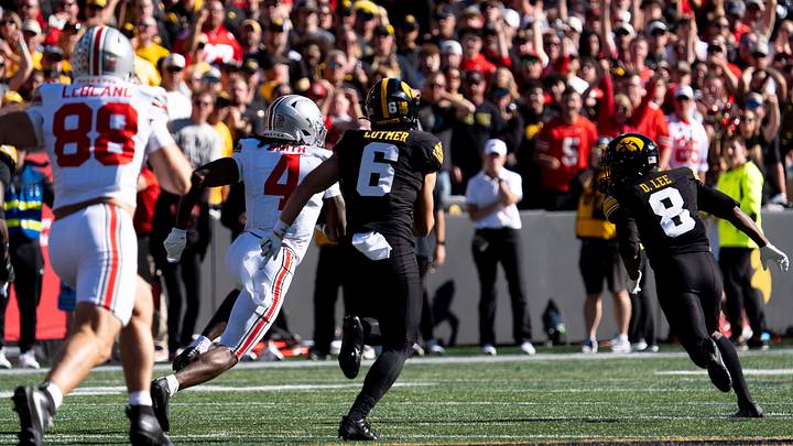 Iowa Hawkeyes defensive backs Zach Lutmer (6) and Deshaun Lee (8) chase Ohio State Buckeyes wide receiver Jeremiah Smith (4) during a Big Ten college football game Oct. 3, 2026 at Kinnick Stadium in Iowa City, Iowa.