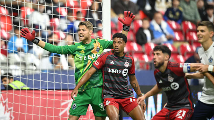 Sep 25, 2024; Vancouver, British Columbia, CAN;  Vancouver Whitecaps FC goalkeeper Isaac Boehmer (32) defends against Toronto FC on a corner kick during the second half at BC Place. Mandatory Credit: Anne-Marie Sorvin-Imagn Images