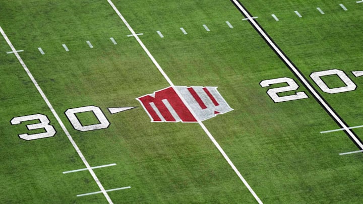 The Mountain West conference logo on the field at Allegiant Stadium. Mandatory Credit: Kirby Lee-Imagn Images
