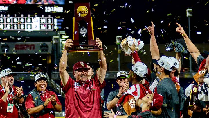 Oklahoma coach Skip Johnson raises the NCAA Championship Trophy after the Sooners won the College World Series. Oklahoma coach Skip Johnson raises the NCAA Championship Trophy after the Sooners won the College World Series.