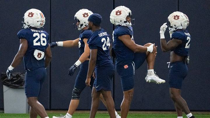 Auburn Tigers running backs warm up during Auburn football practice at Woltosz Football Performance Center.