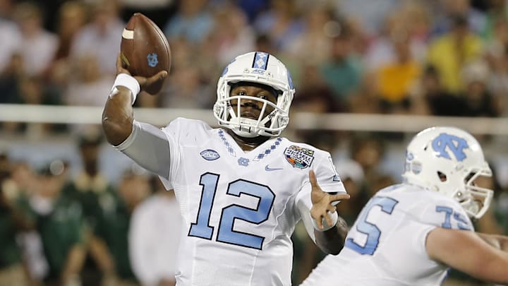 Dec 29, 2015; Orlando, FL, USA; North Carolina Tar Heels quarterback Marquise Williams (12) throws a touchdown pass during the first quarter of the Russell Athletic Bowl against the Baylor Bears at Florida Citrus Bowl. Mandatory Credit: Reinhold Matay-Imagn Images
