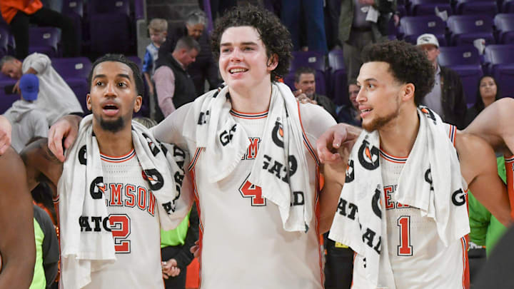 Clemson guard Dillon Hunter (2), left, senior forward Ian Schieffelin (4) and guard Chase Hunter (1) join in the alma mater song after Clemson beat North Carolina 85-65 Monday, Feb 10, 2025; Clemson, South Carolina, USA; at Littlejohn Coliseum.