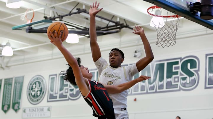 Noah Tanaka of Redwood drives to the basket while defended by Devaughn Dorrough of Monterey Trail. Noah Tanaka of Redwood drives to the basket while defended by Devaughn Dorrough of Monterey Trail.