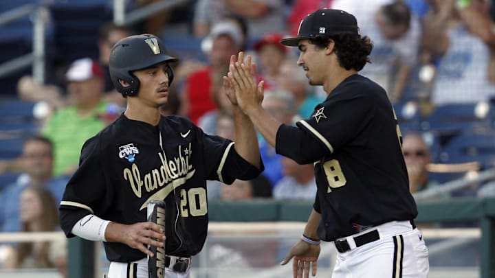 Jun 21, 2014; Omaha, NE, USA; Vanderbilt Commodores runner Bryan Reynolds (20) celebrates his run