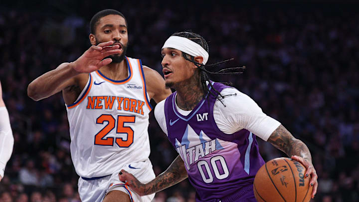 Jan 1, 2025; New York, New York, USA; Utah Jazz guard Jordan Clarkson (00) dribbles as New York Knicks forward Mikal Bridges (25) defends during the first half at Madison Square Garden. Mandatory Credit: Vincent Carchietta-Imagn Images