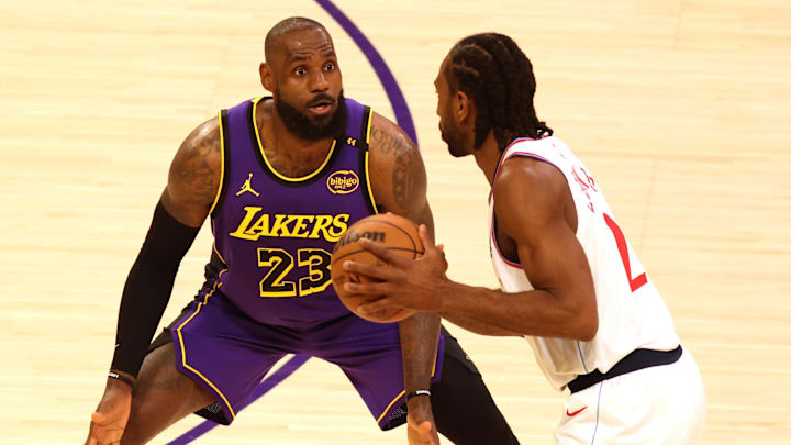 Feb 28, 2025; Los Angeles, California, USA; Los Angeles Lakers forward LeBron James (23) defends LA Clippers forward Kawhi Leonard (2) during the first quarter at Crypto.com Arena. Mandatory Credit: Jason Parkhurst-Imagn Images