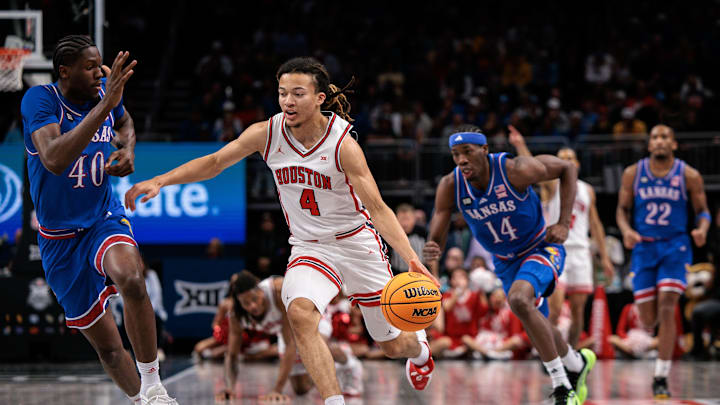 Mar 13, 2026; Kansas City, MO, USA; Houston Cougars guard Kingston Flemings (4) brings the ball up court around Kansas Jayhawks forward Flory Bidunga (40) during the first half at T-Mobile Center. Mandatory Credit: William Purnell-Imagn Images