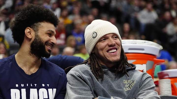 Feb 3, 2025; Denver, Colorado, USA; Denver Nuggets forward Aaron Gordon (32) and guard Jamal Murray (27) on the bench in the second half against the New Orleans Pelicans at Ball Arena. Mandatory Credit: Ron Chenoy-Imagn Images