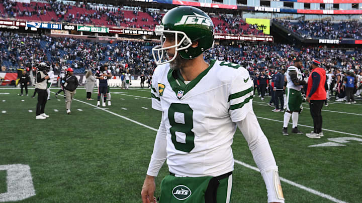 New York Jets quarterback Aaron Rodgers walks off of the field after a game against the New England Patriots.