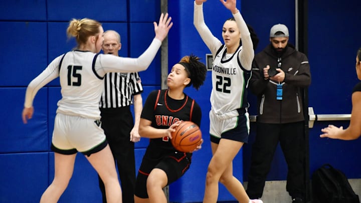 Woodinville's Kamryn Wille, left, and Jazzy Wilkerson surround Union's Myla Larry in Class 4A regional game at Bellevue College.