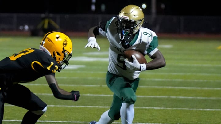 Jeremy Dennis (9) runs the ball for the Bishop Hendricken varsity football team last season