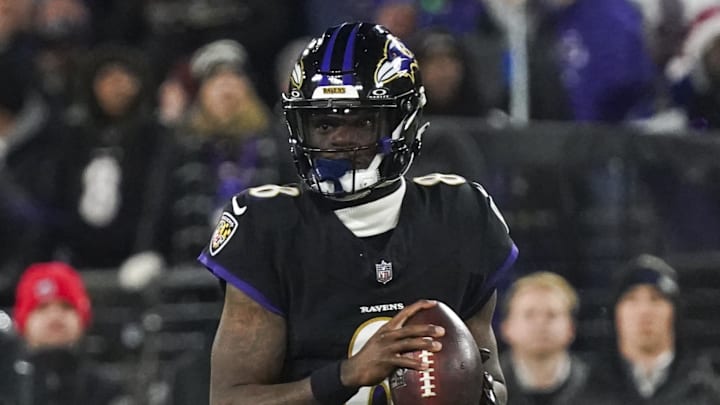 Dec 21, 2025; Baltimore, Maryland, USA;  Baltimore Ravens quarterback Lamar Jackson (8) scrambles against the New England Patriots during the first quarter of the game at M&T Bank Stadium. Mandatory Credit: James Lang-Imagn Images
