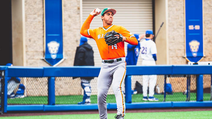 Miami Hurricanes third baseman Daniel Cuvet (14) against Pitt throwing to first baseman Todd Hudson (18)