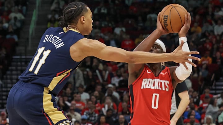 Dec 19, 2024; Houston, Texas, USA;  Houston Rockets guard Aaron Holiday (0) is guarded by New Orleans Pelicans guard Brandon Boston (11) in the second half at Toyota Center. Mandatory Credit: Thomas Shea-Imagn Images