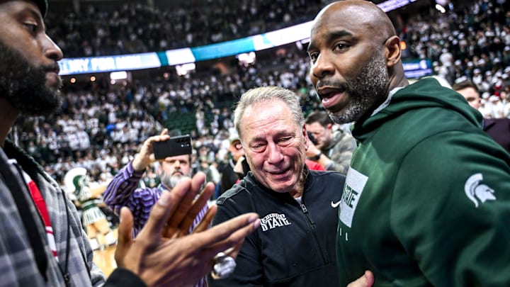 Michigan State's head coach Tom Izzo, center, hugs former player Mateen Cleaves, right, after the Spartans win over Oregon on Saturday, Feb. 8, 2025, at the Breslin Center East Lansing. Former player Mo Peterson, left, look on.