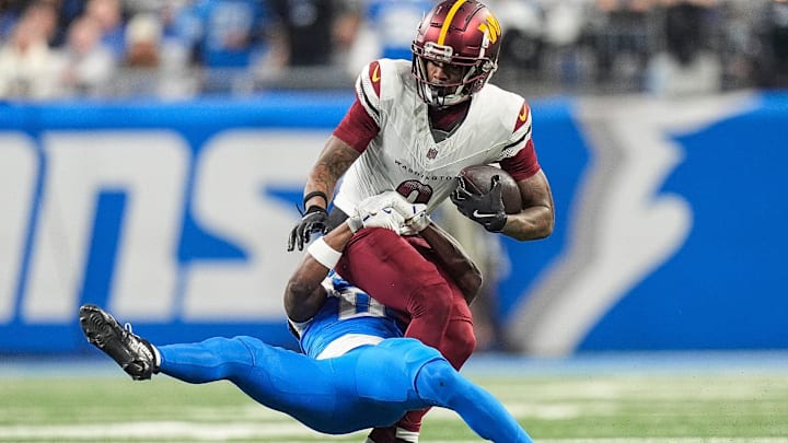 Detroit Lions cornerback Terrion Arnold (0) tackles Washington Commanders wide receiver Dyami Brown (2) 