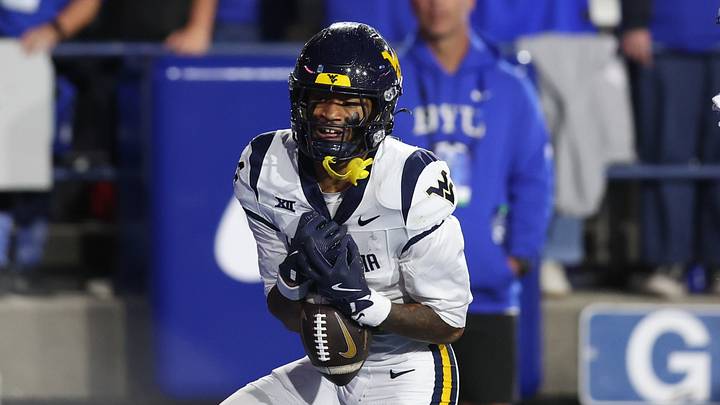 Oct 3, 2025; Provo, Utah, USA; West Virginia Mountaineers wide receiver Cam Vaughn (4) makes a catch for a touchdown against the Brigham Young Cougars during the fourth quarter at LaVell Edwards Stadium. Mandatory Credit: Rob Gray-Imagn Images